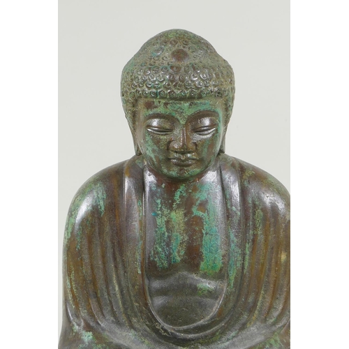 204 - A Chinese patinated bronze figure of Buddha seated in meditation, on a carved hardwood stand, 31cm h... 