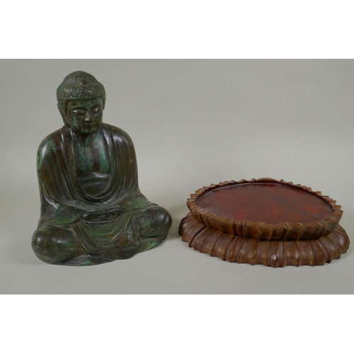 204 - A Chinese patinated bronze figure of Buddha seated in meditation, on a carved hardwood stand, 31cm h... 