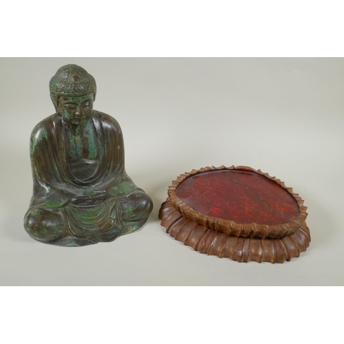 204 - A Chinese patinated bronze figure of Buddha seated in meditation, on a carved hardwood stand, 31cm h... 