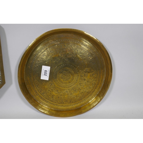 209 - An antique Indian brass tray with lion and elephant decoration, 76cm diameter and another smaller