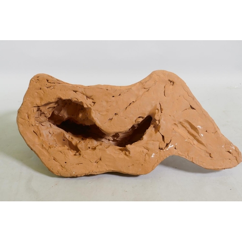 21 - A terracotta sculpture of a reclining nude, inscribed MJ 94, 46 x 21cm