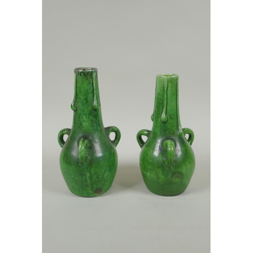 212 - A pair of green glazed Farnham Pottery vases with loop handles, AF, 19cm high