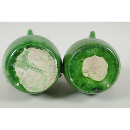 212 - A pair of green glazed Farnham Pottery vases with loop handles, AF, 19cm high