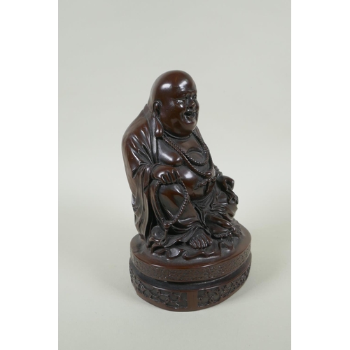 214 - A Chinese bronzed composition figure of a jolly Buddha, 23cm high