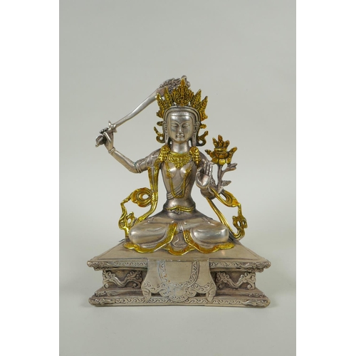 218 - A Tibetan white metal figure of green tara, double vajra mark to base, 21cm high