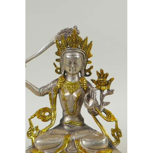 218 - A Tibetan white metal figure of green tara, double vajra mark to base, 21cm high