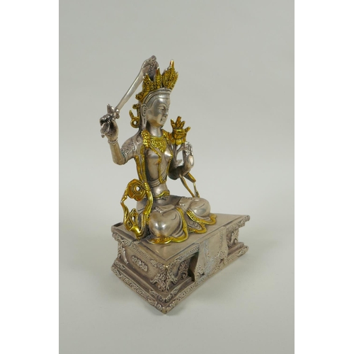 218 - A Tibetan white metal figure of green tara, double vajra mark to base, 21cm high