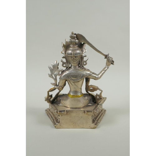 218 - A Tibetan white metal figure of green tara, double vajra mark to base, 21cm high