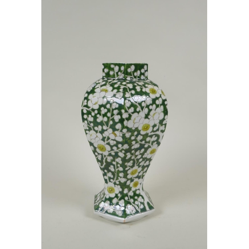 233 - An antique Chinese green ground porcelain baluster vase of hexagonal form, with allover prunus bloss... 