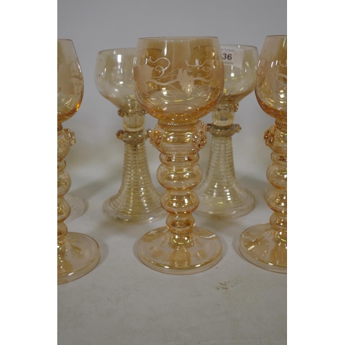 236 - A set of seven C19th amber coloured Hock wine glasses, and five more similar with etched grape and v... 