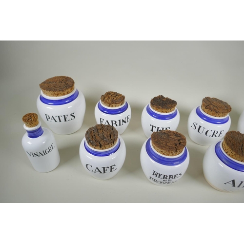 243 - Ten French ceramic blue and white storage pots and bottles with cork lids, largest 17cm  high