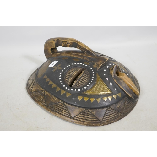 247 - An African tribal mask, inlaid with brass and shells, 43cm diameter