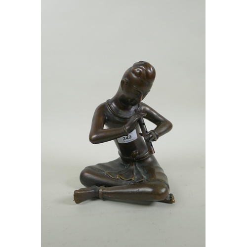 249 - A Thai filled bronze figure of a musician playing the flute, 23cm high