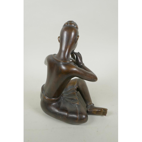 249 - A Thai filled bronze figure of a musician playing the flute, 23cm high