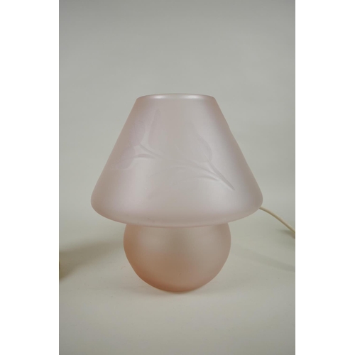 258 - A vintage lilac glass mushroom lamp with etched leaf decoration, and a turned stone and brass mounte... 