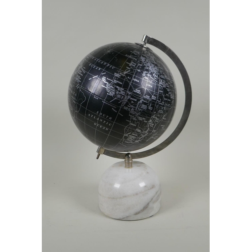 262 - A black terrestrial globe on a reconstituted marble base, produced in India, 33cm high