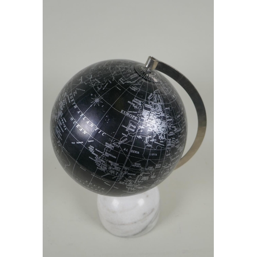 262 - A black terrestrial globe on a reconstituted marble base, produced in India, 33cm high