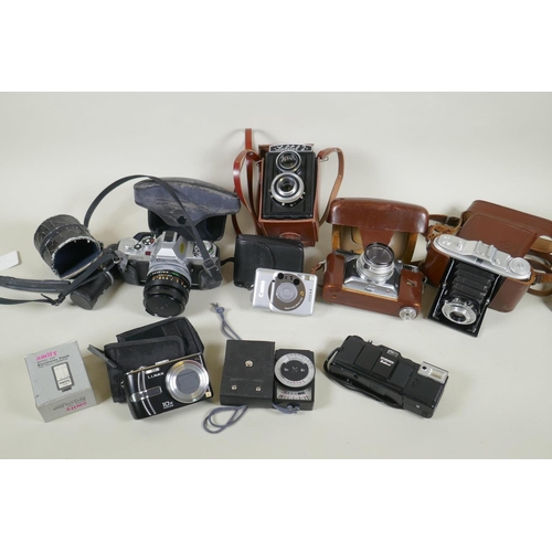 274 - A quantity of vintage 35mm and medium format cameras and accessories, to include a Canon AV-1, a Lub... 