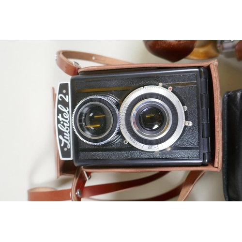 274 - A quantity of vintage 35mm and medium format cameras and accessories, to include a Canon AV-1, a Lub... 