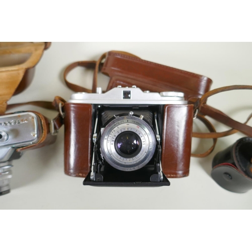 274 - A quantity of vintage 35mm and medium format cameras and accessories, to include a Canon AV-1, a Lub... 