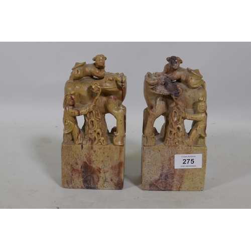 275 - A pair of vintage Chinese carved soapstone bookends in the form of boys with water buffalo, 19cm hig... 