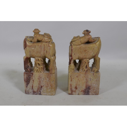 275 - A pair of vintage Chinese carved soapstone bookends in the form of boys with water buffalo, 19cm hig... 