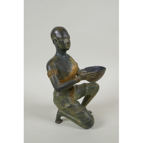 29 - An antique oriental filled bronze figure of a kneeling woman carrying a bowl, 24cm high