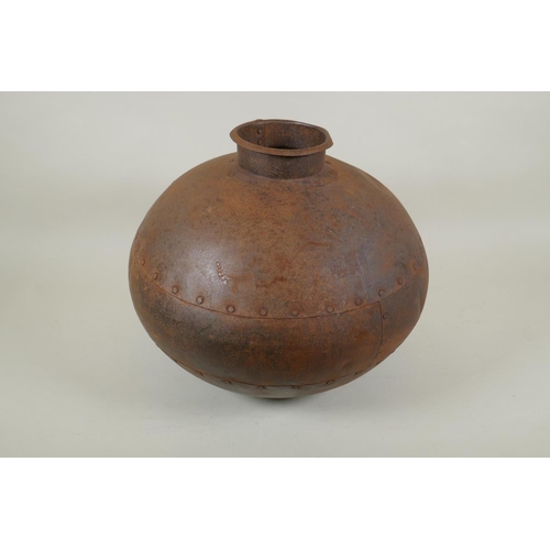 295 - An Indian riveted metal water pot, 30cm high, 35cm diameter