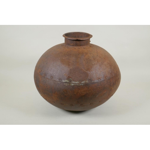 295 - An Indian riveted metal water pot, 30cm high, 35cm diameter