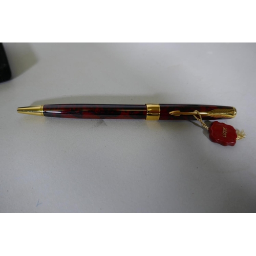 329 - A Watermans gold plated fountain pen with 18ct nib in box, appears unused, and a Parker Sonnet lacqu... 