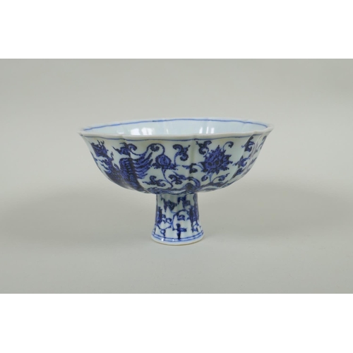 35 - A Chinese blue and white porcelain stem bowl with lobed rim, decorated with phoenix and lotus flower... 