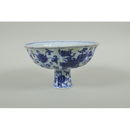 35 - A Chinese blue and white porcelain stem bowl with lobed rim, decorated with phoenix and lotus flower... 