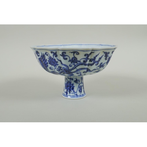 35 - A Chinese blue and white porcelain stem bowl with lobed rim, decorated with phoenix and lotus flower... 