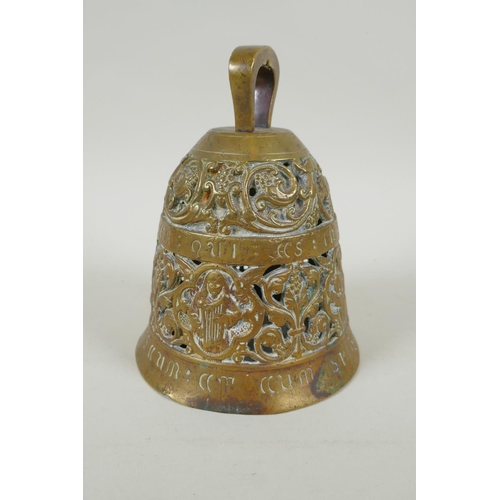 36 - An antique pierced bronze prayer bell decorated with depictions of angelic musicians and Catholic ap... 