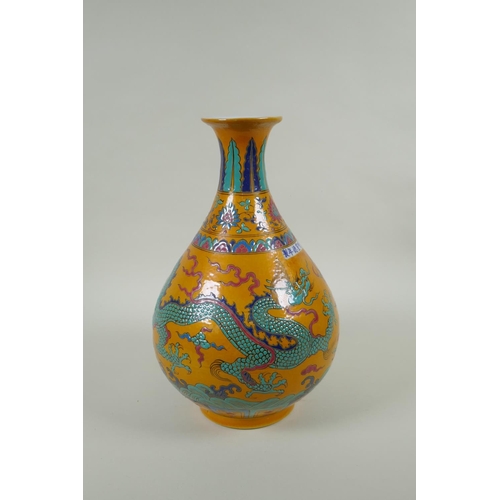 40 - A Chinese yellow ground porcelain pear shaped vase with enamel decoration of a dragon and phoenix, X... 