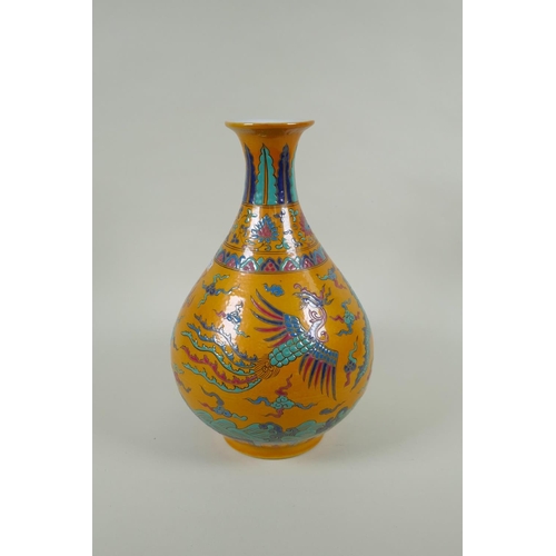 40 - A Chinese yellow ground porcelain pear shaped vase with enamel decoration of a dragon and phoenix, X... 