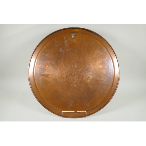 43 - An Islamic silver overlaid copper tray with caligraphic script decoration, 55cm diameter