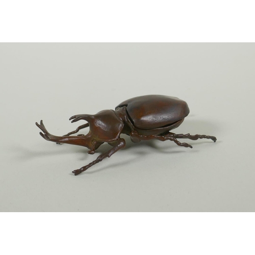 51 - A Japanese style bronze okimono rhinoceros beetle, 9cm long