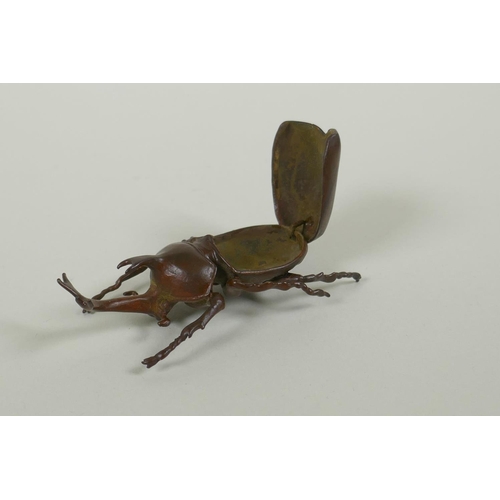 51 - A Japanese style bronze okimono rhinoceros beetle, 9cm long