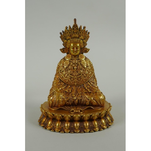 58 - A Sino Tibetan filled gilt bronze Buddha seated on a lotus throne, double vajra mark to base, 11cm h... 