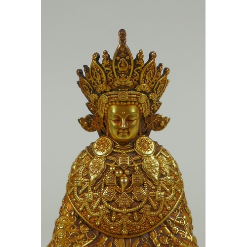 58 - A Sino Tibetan filled gilt bronze Buddha seated on a lotus throne, double vajra mark to base, 11cm h... 