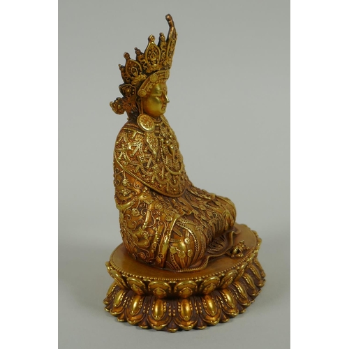 58 - A Sino Tibetan filled gilt bronze Buddha seated on a lotus throne, double vajra mark to base, 11cm h... 