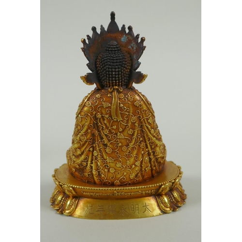 58 - A Sino Tibetan filled gilt bronze Buddha seated on a lotus throne, double vajra mark to base, 11cm h... 