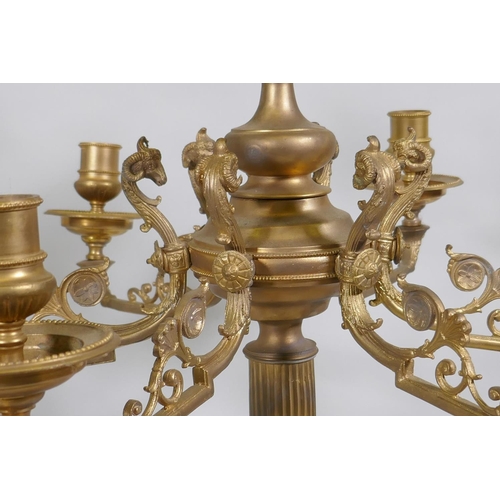 59 - A pair of ormolu brass nine branch candelabra with ram's mask decoration, raised on fluted columns s... 