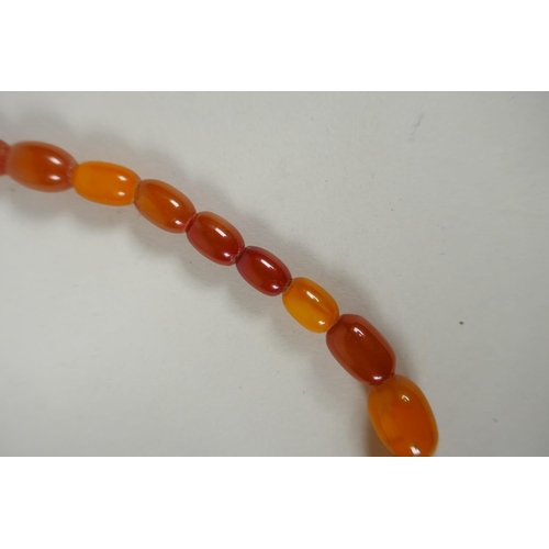 603 - A graduated butterscotch amber bead necklace, 56cm long, 21g