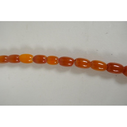 603 - A graduated butterscotch amber bead necklace, 56cm long, 21g