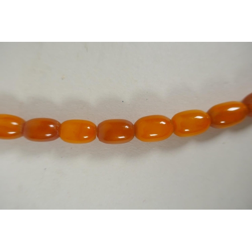 603 - A graduated butterscotch amber bead necklace, 56cm long, 21g