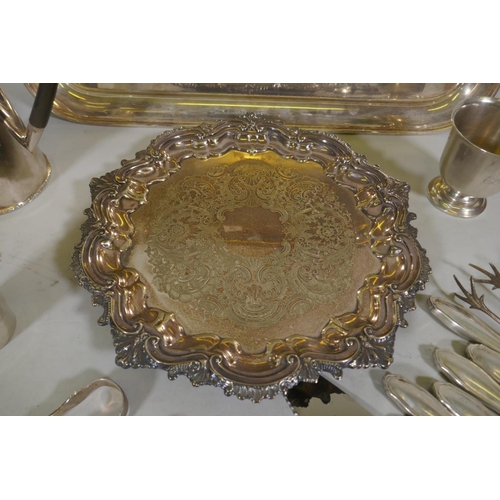 607 - A Sheffield silver plate serving tray, another smaller, silver handled knives and servers, tongs and... 