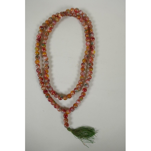 614 - A string of multicolour hardstone/jade mala beads with the remnants of gilt lustre, 122cm long