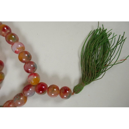 614 - A string of multicolour hardstone/jade mala beads with the remnants of gilt lustre, 122cm long